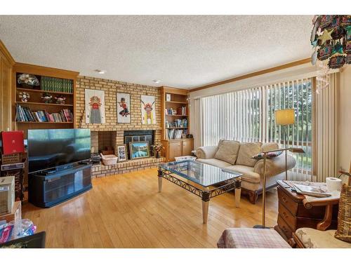 139 Woodacres Drive Sw, Calgary, AB - Indoor Photo Showing Living Room With Fireplace