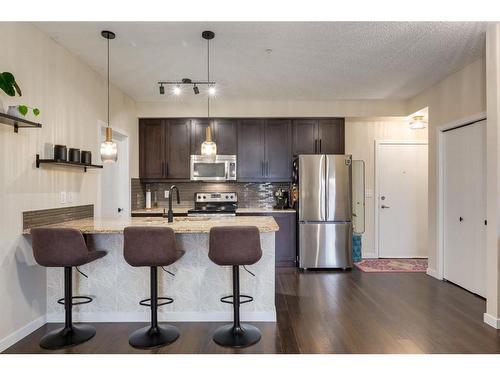 110-402 Marquis Lane Se, Calgary, AB - Indoor Photo Showing Kitchen With Stainless Steel Kitchen With Upgraded Kitchen