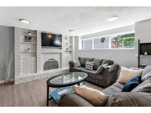 172 Brabourne Road Sw, Calgary, AB - Indoor Photo Showing Living Room With Fireplace