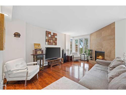 104-350 4 Avenue Ne, Calgary, AB - Indoor Photo Showing Living Room With Fireplace