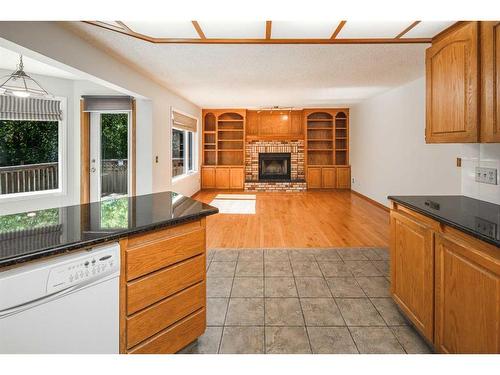48 Hawktree Green Nw, Calgary, AB - Indoor Photo Showing Kitchen With Fireplace