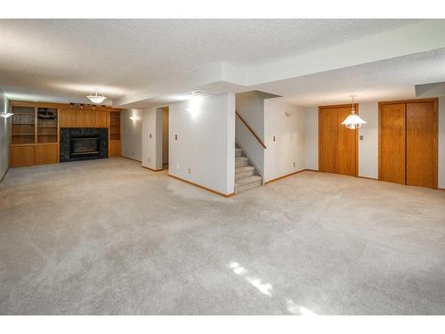 48 Hawktree Green Nw, Calgary, AB - Indoor With Fireplace