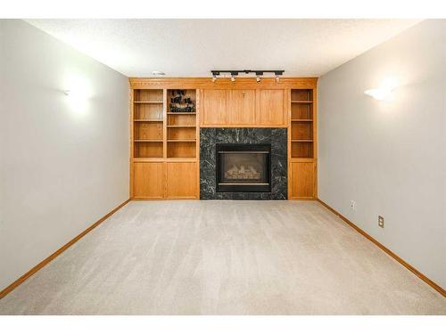48 Hawktree Green Nw, Calgary, AB - Indoor Photo Showing Living Room With Fireplace
