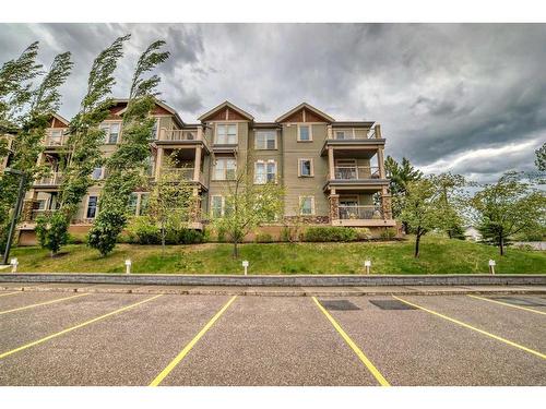 117-205 Sunset Drive, Cochrane, AB - Outdoor With Balcony With Facade