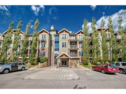 117-205 Sunset Drive, Cochrane, AB - Outdoor With Balcony With Facade