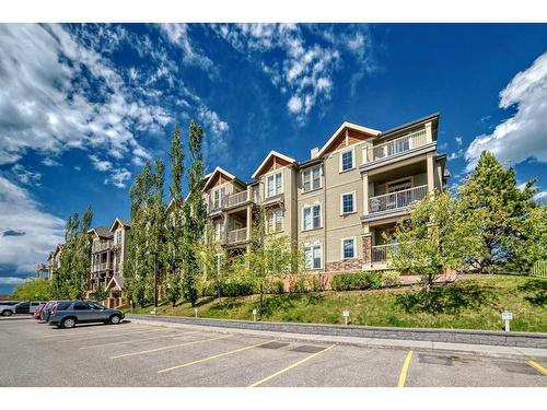 117-205 Sunset Drive, Cochrane, AB - Outdoor With Balcony With Facade
