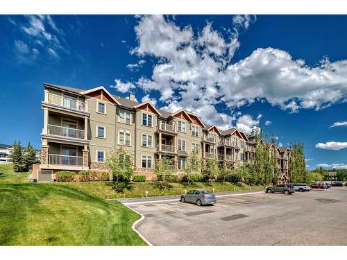 117-205 Sunset Drive, Cochrane, AB - Outdoor With Balcony With Facade