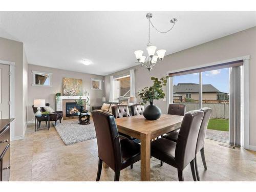 2027 Luxstone Boulevard Sw, Airdrie, AB - Indoor Photo Showing Dining Room With Fireplace