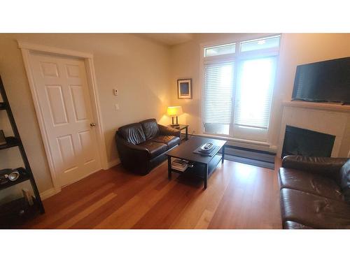 3603-24 Hemlock Crescent Sw, Calgary, AB - Indoor Photo Showing Living Room With Fireplace