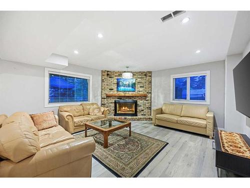 19 Hawkslow Bay Nw, Calgary, AB - Indoor Photo Showing Living Room With Fireplace