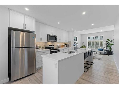 215 Les Jardins Park Se, Calgary, AB - Indoor Photo Showing Kitchen With Stainless Steel Kitchen With Double Sink With Upgraded Kitchen