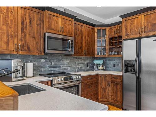 211-75 Dyrgas Gate, Canmore, AB - Indoor Photo Showing Kitchen With Stainless Steel Kitchen