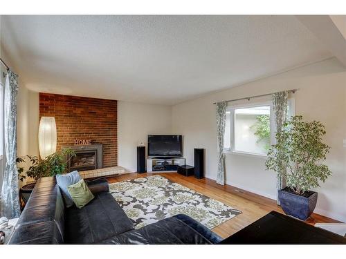 5155 Viceroy Drive Nw, Calgary, AB - Indoor Photo Showing Living Room With Fireplace
