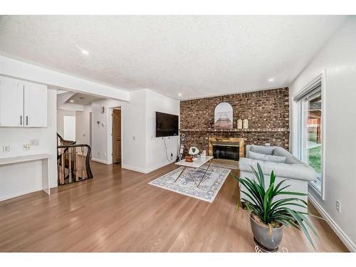 311 Edelweiss Place Nw, Calgary, AB - Indoor Photo Showing Living Room With Fireplace