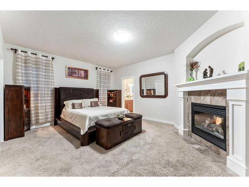 159 Evergreen Circle Sw, Calgary, AB - Indoor Photo Showing Bedroom With Fireplace