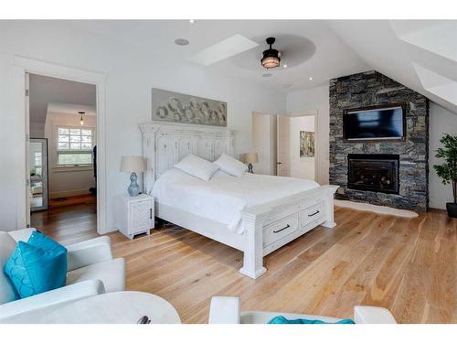 84 Eagle Butte Ranch, Rural Rocky View County, AB - Indoor Photo Showing Bedroom With Fireplace