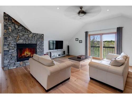 84 Eagle Butte Ranch, Rural Rocky View County, AB - Indoor Photo Showing Living Room With Fireplace