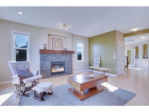168 Heritage Boulevard, Cochrane, AB - Indoor Photo Showing Living Room With Fireplace