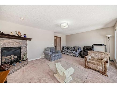 248 Panatella Cape Nw, Calgary, AB - Indoor Photo Showing Living Room With Fireplace