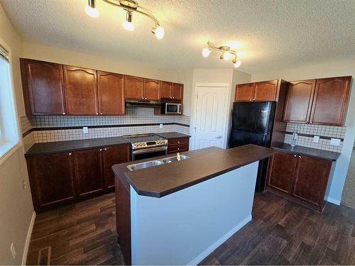 184 Silverado Plains Close Sw, Calgary, AB - Indoor Photo Showing Kitchen With Double Sink