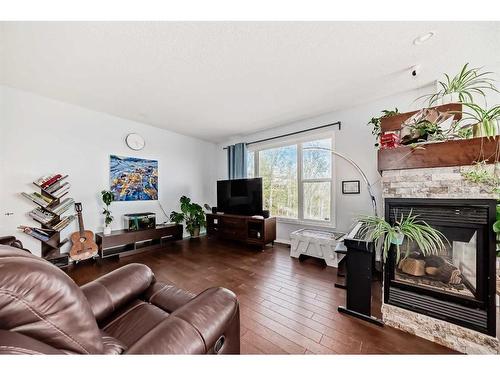 121 Cortina Bay Sw, Calgary, AB - Indoor Photo Showing Living Room With Fireplace