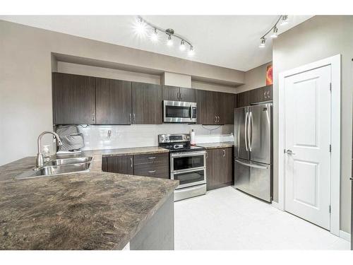 314-100 Cranfield Common Se, Calgary, AB - Indoor Photo Showing Kitchen With Double Sink
