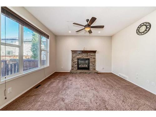 1204 New Brighton Drive Se, Calgary, AB - Indoor Photo Showing Living Room With Fireplace
