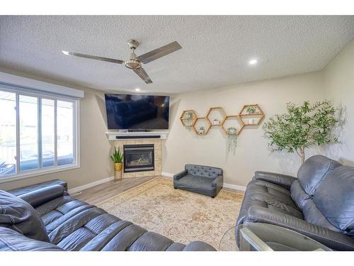 258 Bayside Point Sw, Airdrie, AB - Indoor Photo Showing Living Room With Fireplace