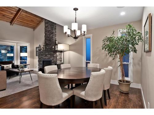 240 Woodridge Place Sw, Calgary, AB - Indoor Photo Showing Dining Room With Fireplace