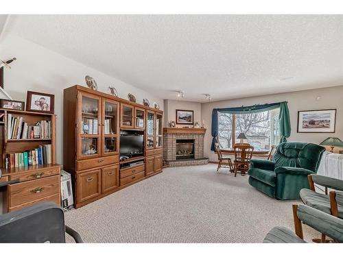 28 Eagleview Gate, Cochrane, AB - Indoor Photo Showing Living Room With Fireplace