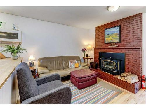 8824 33 Avenue Nw, Calgary, AB - Indoor Photo Showing Living Room With Fireplace