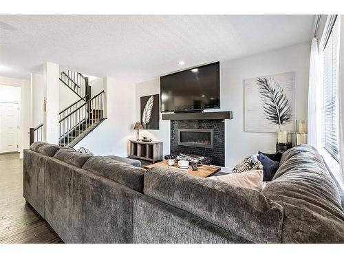 16 Marquis Grove Se, Calgary, AB - Indoor Photo Showing Living Room With Fireplace