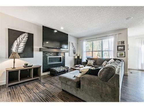 16 Marquis Grove Se, Calgary, AB - Indoor Photo Showing Living Room With Fireplace