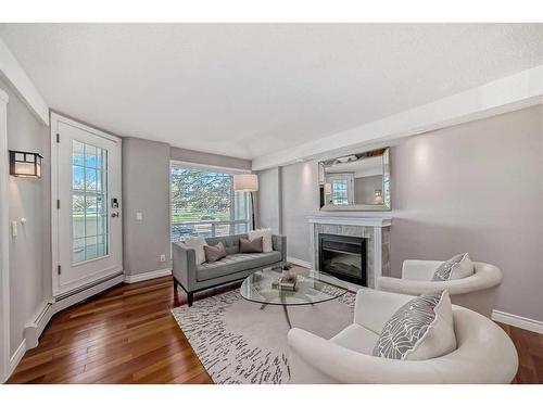 108-2211 29 Street Sw, Calgary, AB - Indoor Photo Showing Living Room With Fireplace