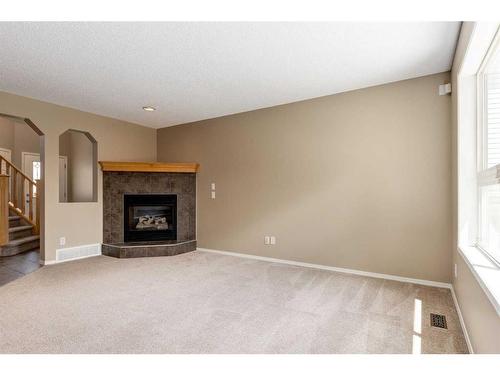 107 Brightondale Crescent Se, Calgary, AB - Indoor Photo Showing Living Room With Fireplace