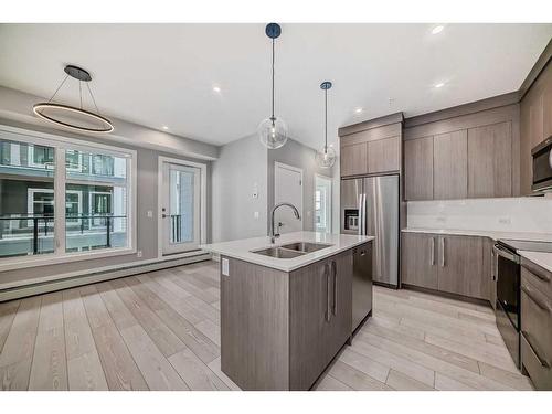 1307-681 Savanna Boulevard Ne, Calgary, AB - Indoor Photo Showing Kitchen With Stainless Steel Kitchen With Double Sink With Upgraded Kitchen