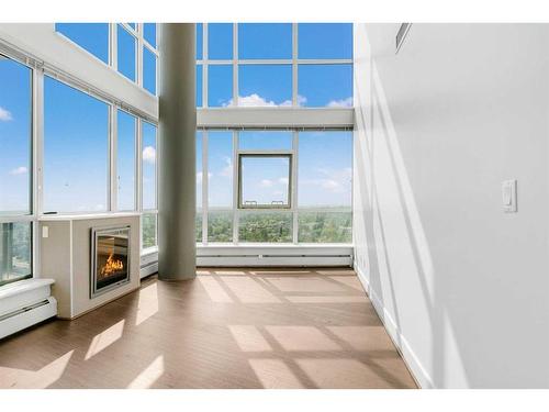 2102-99 Spruce Place Sw, Calgary, AB - Indoor With Fireplace