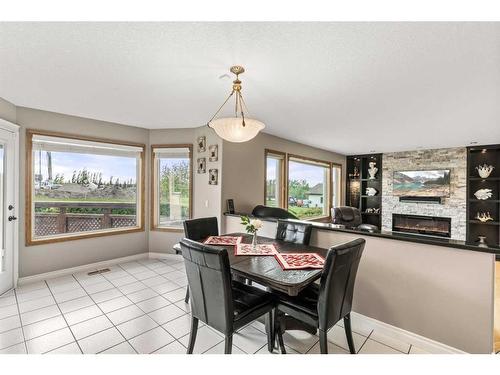 243127 Range Road 281A, Rural Rocky View County, AB - Indoor Photo Showing Dining Room With Fireplace