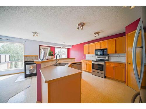 49 Rocky Ridge Green Nw, Calgary, AB - Indoor Photo Showing Kitchen With Double Sink