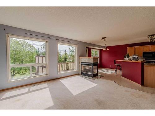 49 Rocky Ridge Green Nw, Calgary, AB - Indoor Photo Showing Living Room With Fireplace
