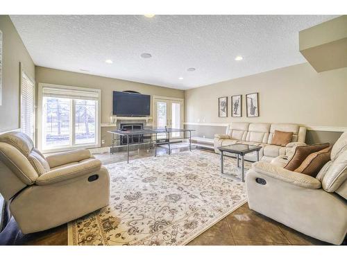 19 Aspen Meadows Manor Sw, Calgary, AB - Indoor Photo Showing Living Room With Fireplace