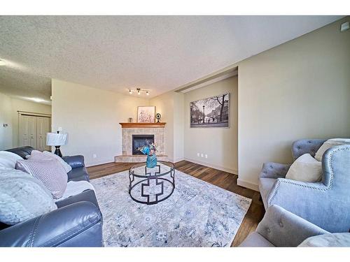 12 Crestmont Way Sw, Calgary, AB - Indoor Photo Showing Living Room With Fireplace