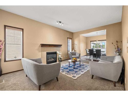 735 New Brighton Drive Se, Calgary, AB - Indoor Photo Showing Living Room With Fireplace