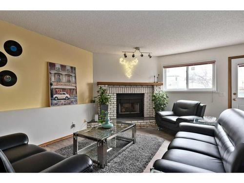 501 Hawkstone Drive Nw, Calgary, AB - Indoor Photo Showing Living Room With Fireplace