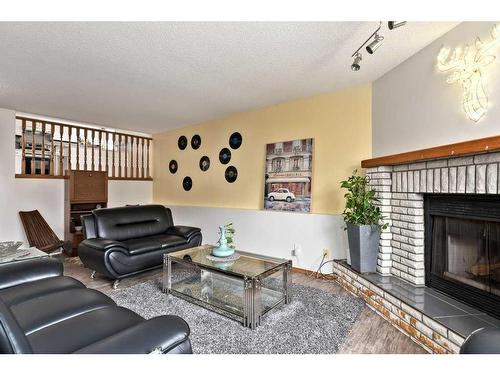 501 Hawkstone Drive Nw, Calgary, AB - Indoor Photo Showing Living Room With Fireplace