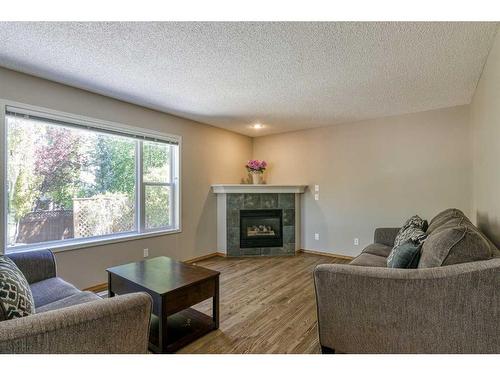 10782 Valley Springs Road Nw, Calgary, AB - Indoor Photo Showing Living Room With Fireplace