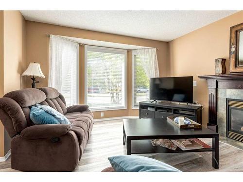 7164 Sierra Morena Boulevard Sw, Calgary, AB - Indoor Photo Showing Living Room With Fireplace