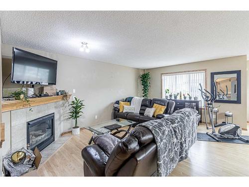 115 Panamount Heights Nw, Calgary, AB - Indoor Photo Showing Living Room With Fireplace