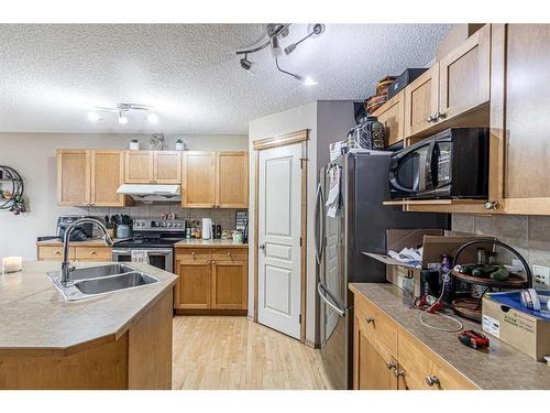 115 Panamount Heights Nw, Calgary, AB - Indoor Photo Showing Kitchen With Double Sink