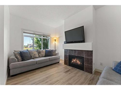 57 Copperpond Landing Se, Calgary, AB - Indoor Photo Showing Living Room With Fireplace